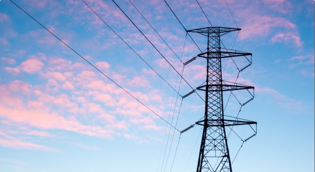 A powerline against a sky at sunset